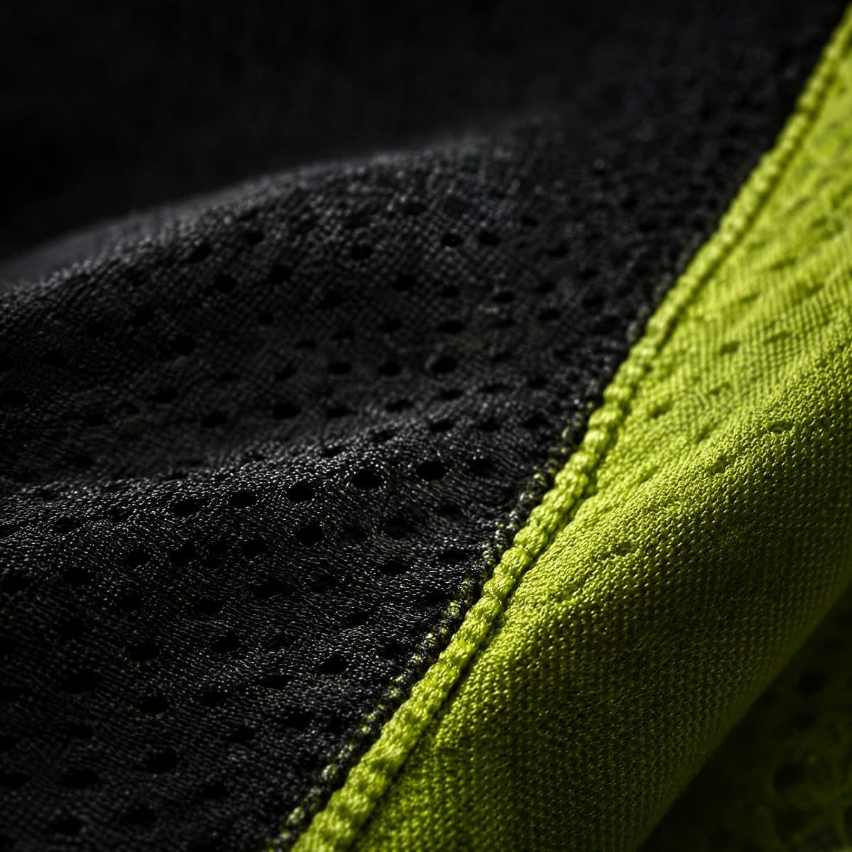 Close-up of perforated black mesh with a lime stripe